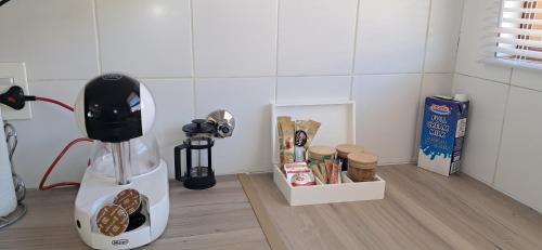 a blender sitting on a counter next to a box of food at Bandile's cosy home in Honeydew