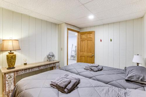 two twin beds in a room with a window at Waterfront Home on Duck Lake 8 Mi to State Park! in Grawn