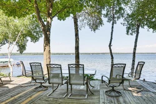 a group of chairs and a table on a dock next to the water at Waterfront Home on Duck Lake 8 Mi to State Park! in Grawn