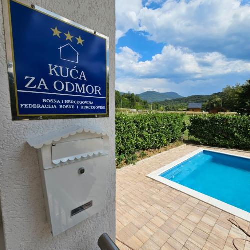 a sign for a villa zena olor with a swimming pool at Vikendica na Sani Datea in Sanski most