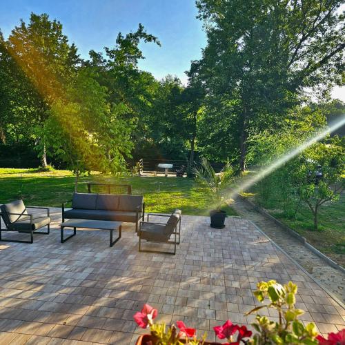 a fire hydrant spraying water on a patio with benches at Vikendica na Sani Datea in Sanski most