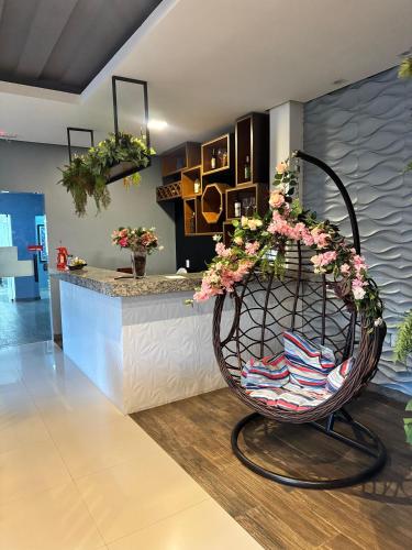 a lobby with a chair in front of a counter at INACIO'S PLAZA HOTEL in Marabá