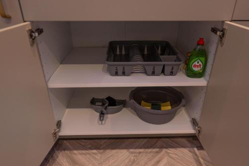 a cupboard with a drawer with tools in it at Royal Suite in 's-Gravenzande