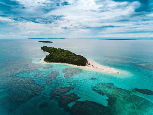 an island in the ocean with rocks in the water at La Loma Jungle Lodge and Chocolate Farm in Bocas del Toro
