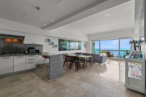 a kitchen and dining room with a view of the ocean at Deck12 Casino and Resort by Monyxbnb in Puerto Vallarta