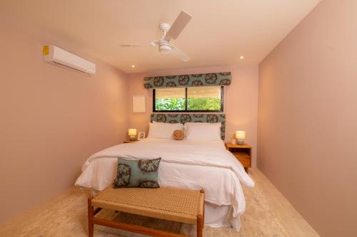 a bedroom with a large bed and a window at Casa Contento - luxury 3bdr home near Santa Teresa in Boca de Ario