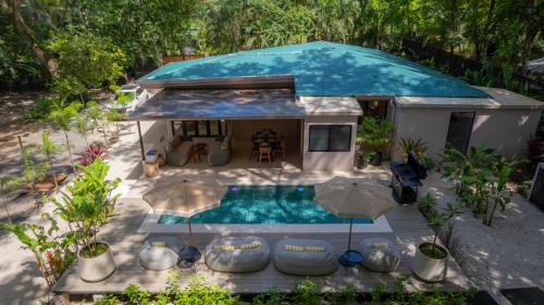 an aerial view of a tiny house with a swimming pool at Casa Contento - luxury 3bdr home near Santa Teresa in Boca de Ario