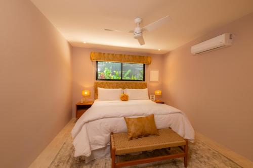 a bedroom with a bed and a window at Casa Contento - luxury 3bdr home near Santa Teresa in Boca de Ario