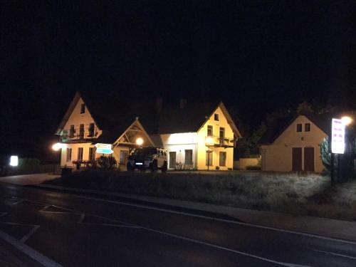 a row of houses at night with lights on at Penzion a restaurace Lemberk in Jablonné v Podještědí