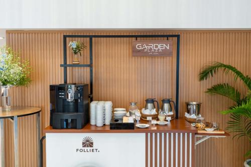 a coffee shop with a coffee maker on a counter at Garden Plaza Saigon - Formerly PARKROYAL Saigon in Ho Chi Minh City