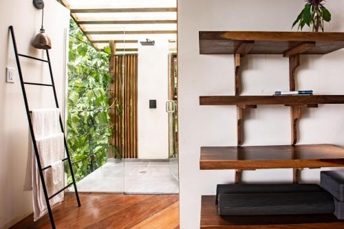 a room with a ladder next to a door at La Loma Jungle Lodge and Chocolate Farm in Bocas del Toro
