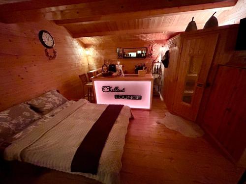 a bedroom with a bed in a wooden room at Wellness-Ferienwohnung mit Sauna, Massagen, beheizbarem Whirlpool & eigener Bierzapfanlage in Pomssen