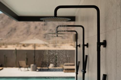 a water fountain in front of a swimming pool at RESET Hotel Joshua Tree in Twentynine Palms