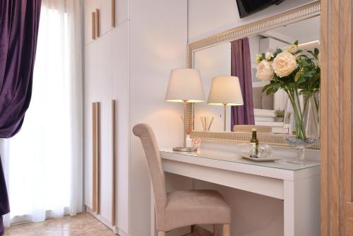a room with a desk with a mirror and a chair at Epavlis Luxury apts in Leptokaria
