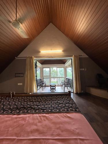 a bedroom with a large bed in a attic at Cottage on Riverside in Irinjālakuda