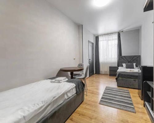 a bedroom with a bed and a desk and a table at Villa Vlad & Spa in Bukovel