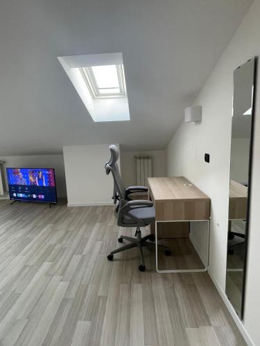 an office with a chair and a desk and a tv at Casa Aaron in Gorgonzola