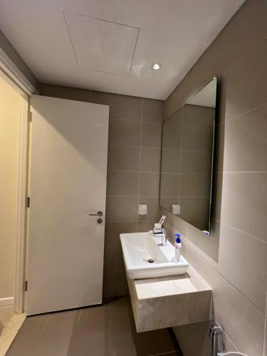 a bathroom with a sink and a mirror at Căn hộ cao cấp Diamond Island Luxury Apartment in Ho Chi Minh City