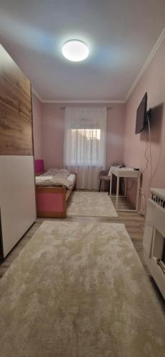 a room with a bed and a desk in it at Bella Z Apartman in Kaposvár