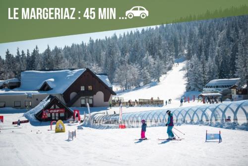 a group of people on skis in the snow at Chez Fred 202 - Parking Wifi Balcon in Saint-Pierre-dʼAlbigny