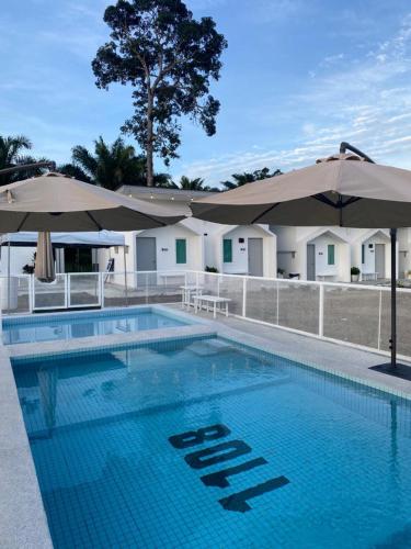 a large swimming pool with umbrellas at 1108 Pedas Village Resort in Pedas