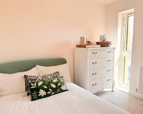 a bedroom with a bed and a dresser at Quiet Cosy Room with Private Bathroom & LUSH Products in Rainham