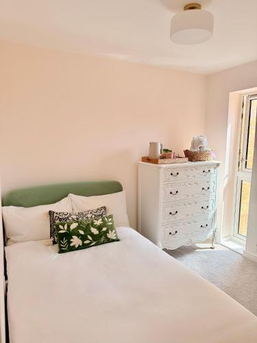 a bedroom with a white dresser and a bed at Quiet Cosy Room with Private Bathroom & LUSH Products in Rainham