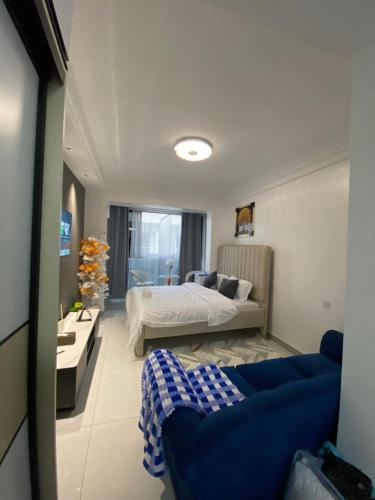 a bedroom with a bed and a couch in a room at Haven 254 New Rise Gardens in Nairobi
