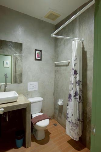 a bathroom with a toilet and a sink and a shower at Surachet at 257 Boutique House in Phuket