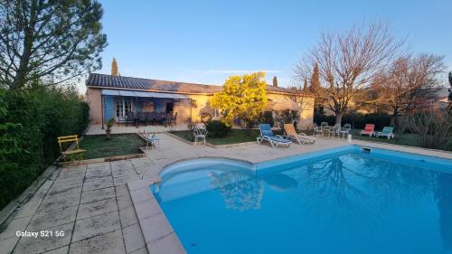 a swimming pool in front of a house at Mas de la Cigaline Gîte & chambres d'hôtes Var in Garéoult