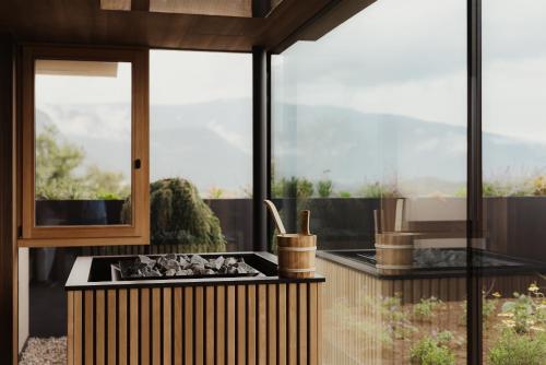 a outdoor kitchen with a stove and a window at Hotel B&B Feldmessner in Brunico