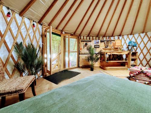 a room with a bed in a yurt at Waterfront CedarGrove Yurt-Glamp in Red Bay