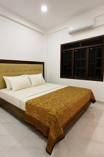 a bedroom with a large bed in a room at Nallur Heritage Villa in Jaffna