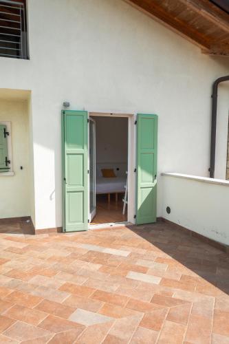 an empty room with green doors and a table at Agritur Stefenelli in Nago-Torbole
