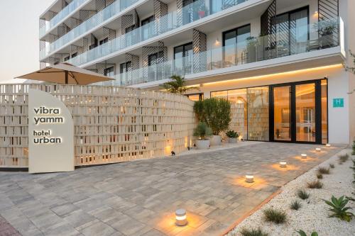 a building with a patio with an umbrella at Hotel Vibra Yamm Urban -New Opening 2025 in San Antonio