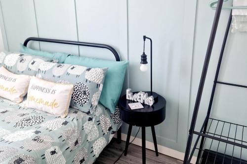 a bedroom with a bed with pillows and a table at Chalet Ty Lilli Wen -Sleep 6- Pet friendly in Kidwelly