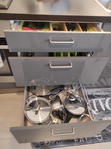 a drawer filled with dishes and spoons at Margot's House Rho in Rho