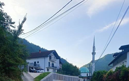 a house on the side of a hill with a tv antenna at Apartment Horizontes Azules in Konjic