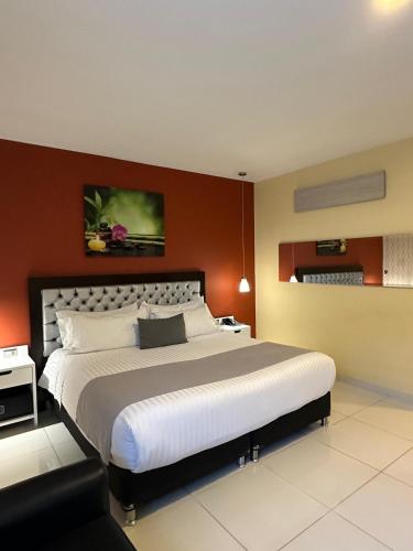 a bedroom with a large bed in a room at Mirago Hotel in Yumbo