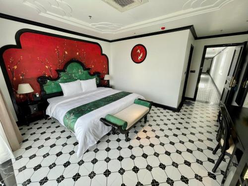 a bedroom with a large bed and a tiled floor at C'Lau Hotel Ninh Binh in Ninh Binh