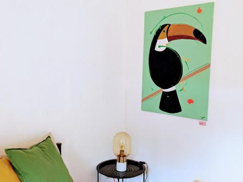 a painting of a penguin hanging on a wall at Don Jiménez Guesthouse in Puerto Jiménez
