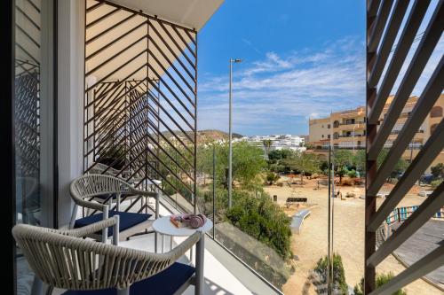 a balcony with two chairs and a table with a view at Hotel Vibra Yamm Urban -New Opening 2025 in San Antonio