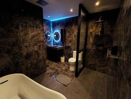 a large bathroom with a tub and a sink at Dreamwood Villa Sakeh in Muar