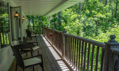a porch with chairs and a table on a house at Wilder Inn in Ephraim