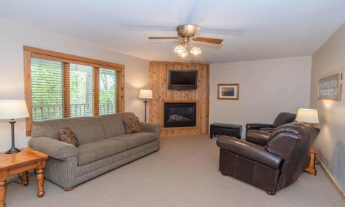 a living room with a couch and a fireplace at Wilder Inn in Ephraim