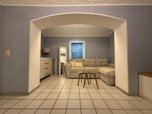 a living room with a couch and a table at Boho & Loft 2 Zimmer Parkplatz in Bad Hersfeld