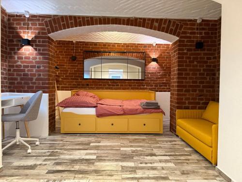 a room with a bed in a brick wall at Boho & Loft 2 Zimmer Parkplatz in Bad Hersfeld