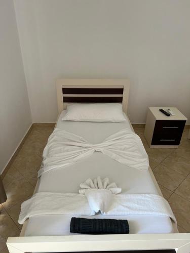 a large white bed with a bow tie on it at Home Majka in Sarandë