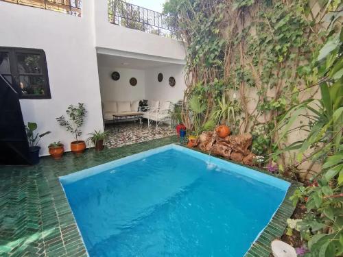 a swimming pool in the backyard of a house at Spacious Apartment in Fès with Private Pool, 150 sqm in Fez