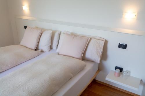 a white couch with pillows on it in a room at Agritur Stefenelli in Nago-Torbole